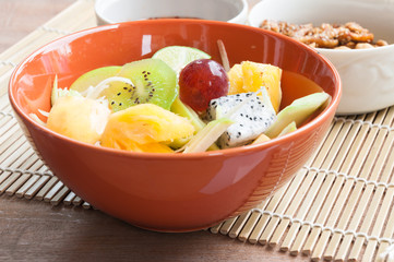 Delicious fruits salad in plate on table close-up, clean food