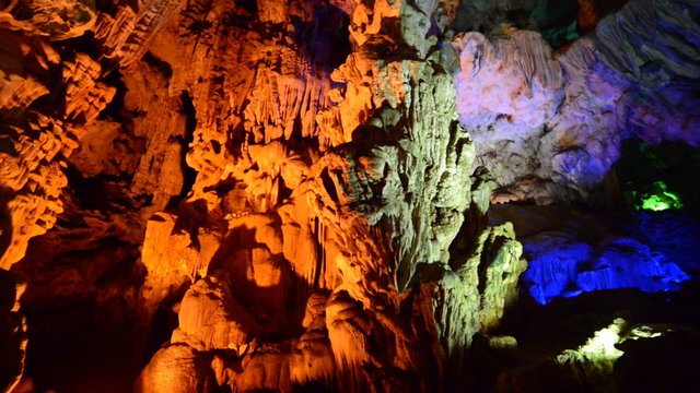Colorized Stalactites hang from Cave Ceiling in Ha Long Bay Vietnam