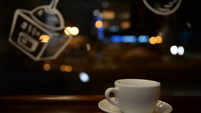 Teapot, cup closeup at night cafe, a restaurant on the street ba