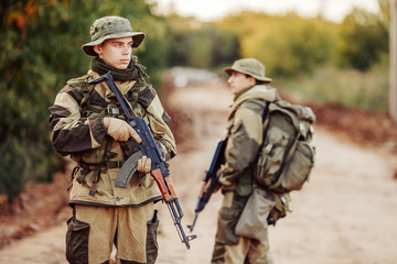 Fototapeta premium Two soldiers are exploring an unfamiliar area