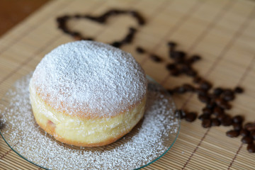 Donut with powdered sugar on the brown plate