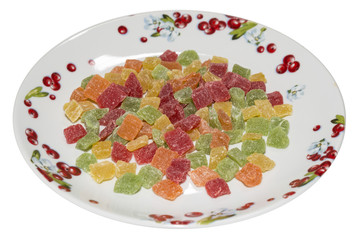 Candied fruits on porcelain plate isolated on white