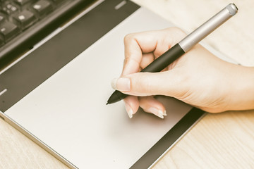 Retro image of female hand of a designer drawing