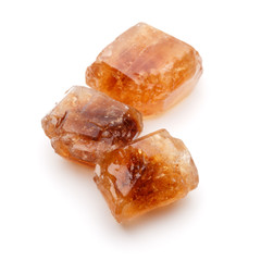 Brown caramelized lump cane sugar cube isolated on white backgro