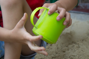 Boy with a cup of sand