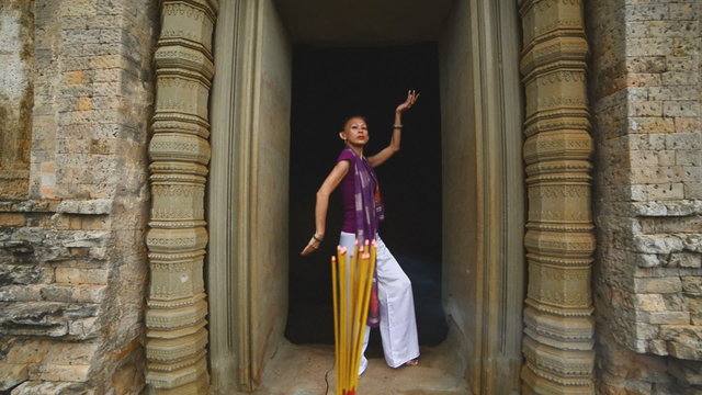 Female Posing like Buddhist Statue in Temple Doorway with Incense-  Angkor Wat Temple Cambodia
