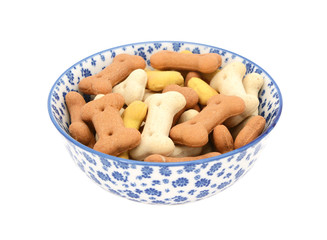 Dog biscuits in a blue and white china bowl