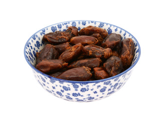 Whole dates in a blue and white china bowl