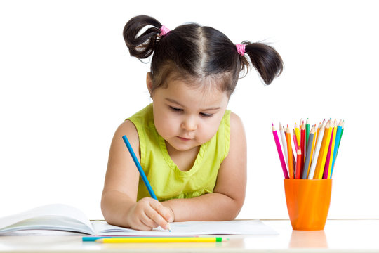Cute child drawing with colorful crayons
