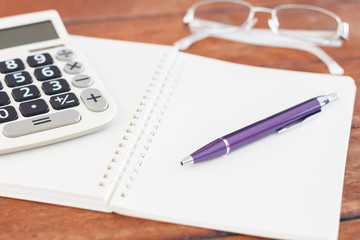 Blank notebook with pen on wooden table