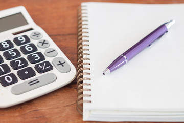 Blank notebook with pen on wooden table