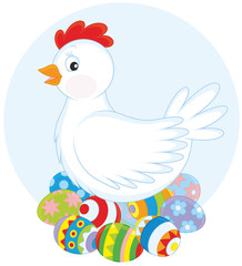 White hen sitting on painted Easter eggs