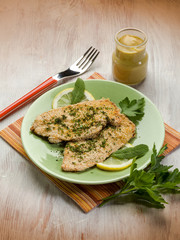 breaded cutlet with herbs and mustard