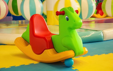 Obraz premium Bright toy rocking horse on the playground