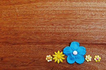 yellow and blue  paper flower on wooden background