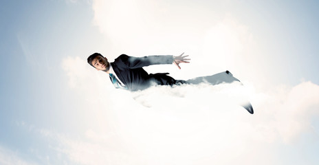 Business man flying like a superhero in clouds on the sky
