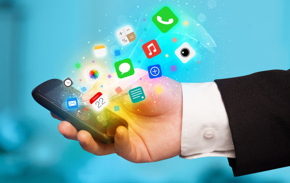 Hand holding smartphone with colorful app icons