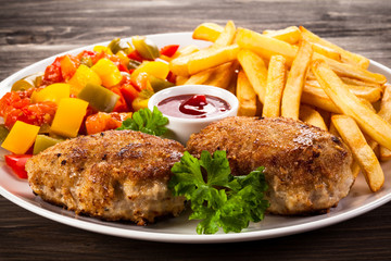 Fried chops, French fries and vegetable salad