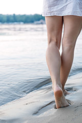 woman walking on sand beach