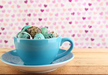 Bird colorful eggs in mug on bright background