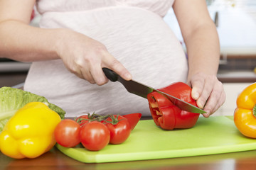 Pregnant Woman Chopping Up Fresh Vegetables