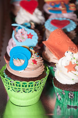 Fototapeta na wymiar Cupcake with colorful figures made of fondant