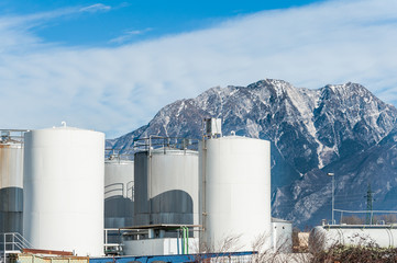 Obraz premium Industrial plant with behind the Italian Alps