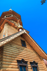 Wooden church on river bank in the summer.