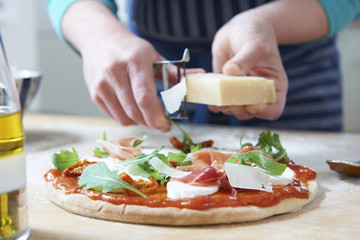 Adding Ingredients To Home Made Pizza
