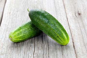 Fresh cucumbers on the wooden background