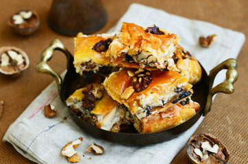 Brass tray with homemade baklava with honey, walnut and raisin