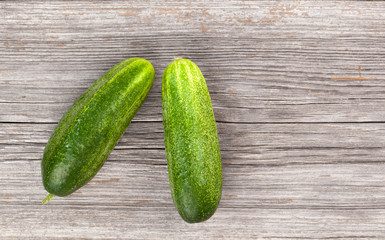 Fresh cucumbers on the wooden background