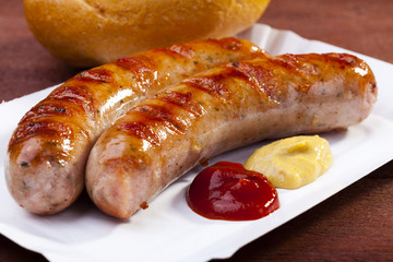 Roasted sausage with bread served on a paper tray