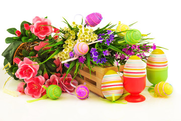 Obraz na płótnie Canvas Flowers in wooden basket with easter eggs