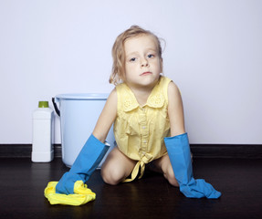 little girl washes the floor