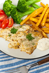 Fish dish - fried fish fillet with vegetables. Selective focus.