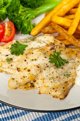 Fish dish - fried fish fillet with vegetables. Selective focus.