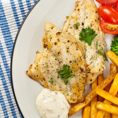 Fish dish - fried fish fillet with vegetables. Selective focus.