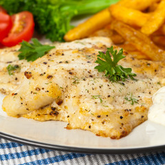Fish dish - fried fish fillet with vegetables. Selective focus.