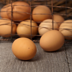 Brown eggs on a rustic wooden background. Selective focus.
