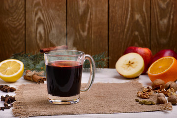 Mulled wine, punch and spices for glintwine on wooden background
