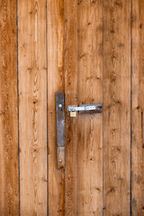 Fototapeta na wymiar old door handle on barn wooden door