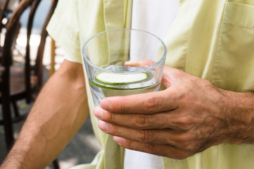 Fototapeta na wymiar man holding a glass of water