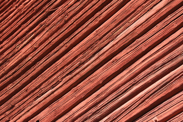 Old red wooden wall in sunlight