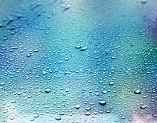 blue background. Liquid on dirty glass. (selective focus)