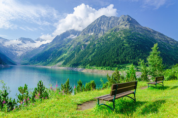 Empty bench in front of the azure mountain lake, Zillertal, Alps