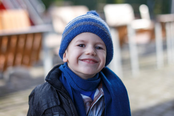 Little boy in winter cap and scarf