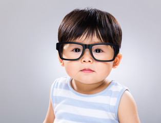 Asian baby wearing glasses