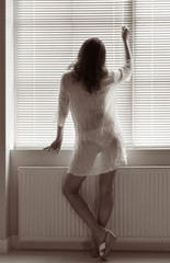 A woman near the window at home