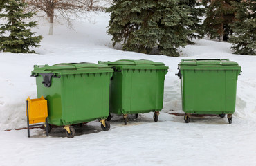 Green recycling containers in the winter park